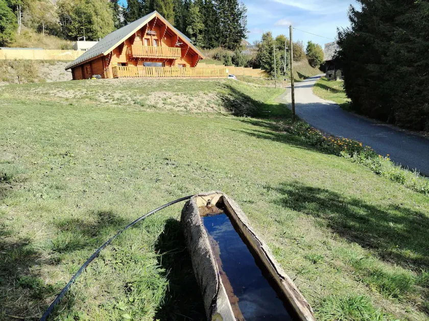 New traditional chalet in a mountain village in the Alps. - Image 1