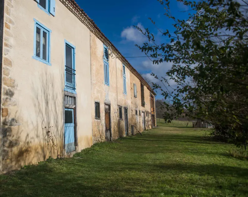 An old farmhouse surrounded by fields near a greenway - Image 1