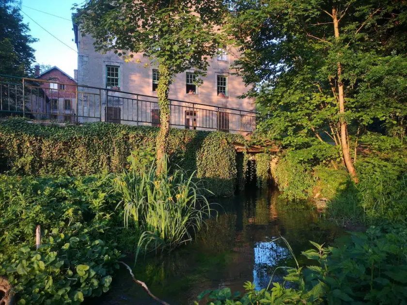 Romantic mill adorned with flowers and water - Image 1
