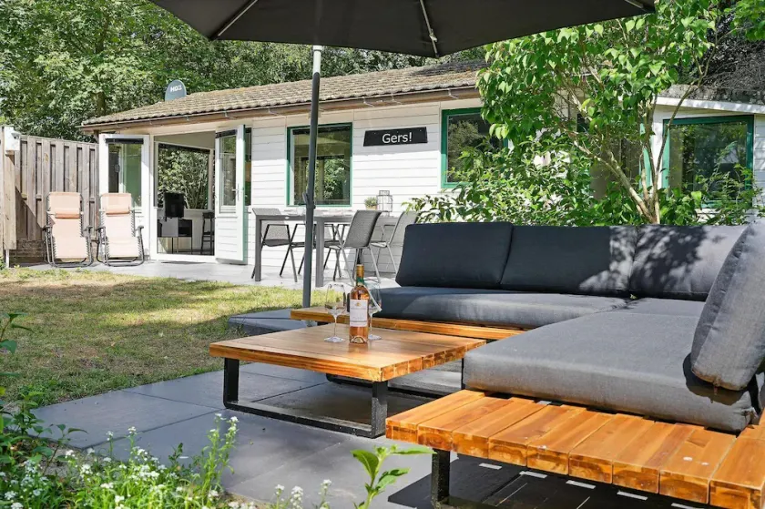The holiday home boasts a delightful garden and modern interior for a carefree vacation close to the sea and dunes. - Image 1