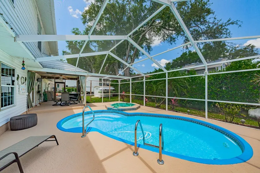 WOW…..beaches just 2 miles away, heated pool, hot tub and room for boat or RV. - Image 1