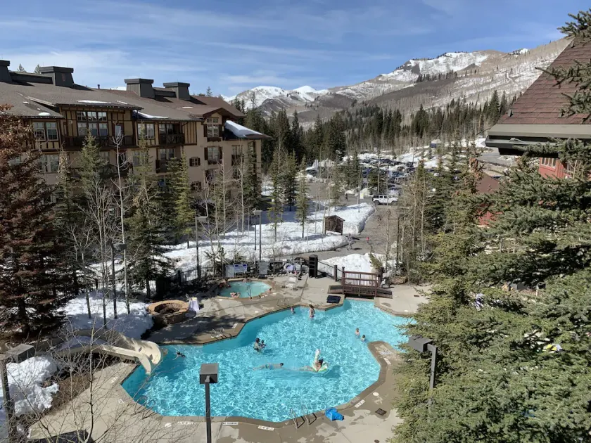 ski-in - ski-out condo with a deck ski views & a shared pool and hot tub - Image 1