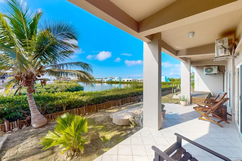 Vibrant, colorful lagoon-front suite with pool access, scenic patio, & W/D - Image 1