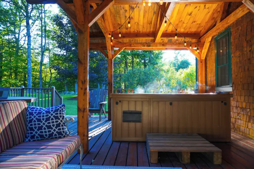 Central Escape is a spacious Lakes Region retreat just 5 minutes from downtown Meredith, less than a mile to Squam Lake and 20 minutes to concerts at the Bank of New Hampshire Pavilion. Enjoy the private year-round hot tub, fire pit, yard games! - Image 1