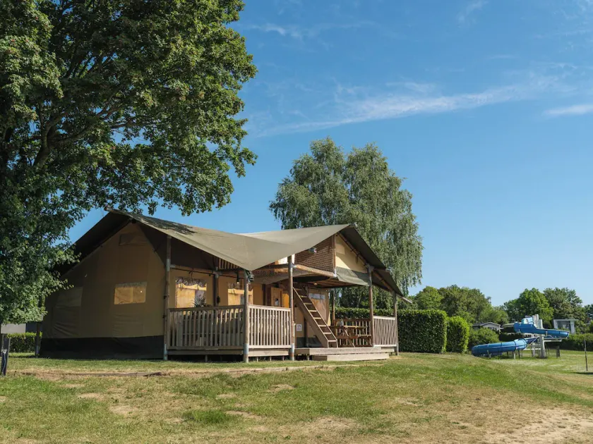 Experience luxury glamping in the elevated Safari Tent Ranger by the water. - Image 1
