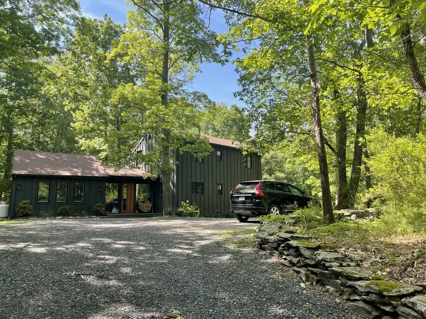 Experience Woodstock charm while staying in a cozy cabin in the woods - Image 1
