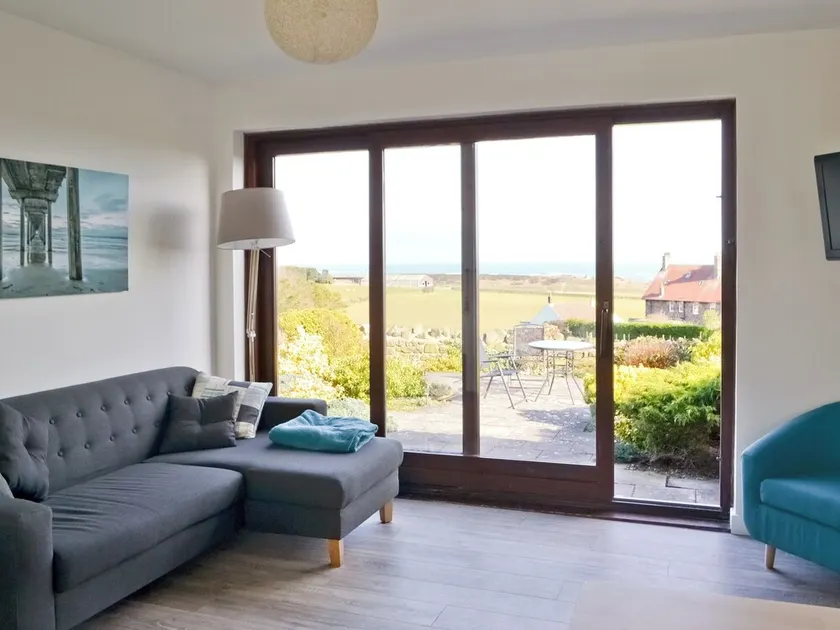 Part of a small terrace of bungalows with uninterrupted views towards the sea. - Image 1