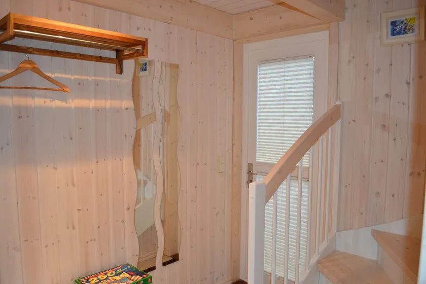 Child-friendly vacation home \"Kuschelmuschel 14\" in Baabe. A relaxing getaway with a sauna and hot tub, a washing machine, a furnished patio, and just about 150 meters from the beach. - Image 1