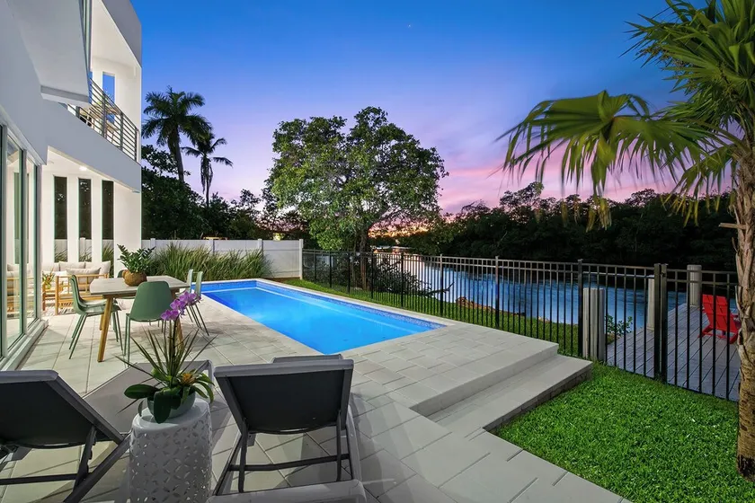The Riverhouse – A Stunning Modern Heated Pool Retreat with Serene and Scenic Waterway Views! - Image 1