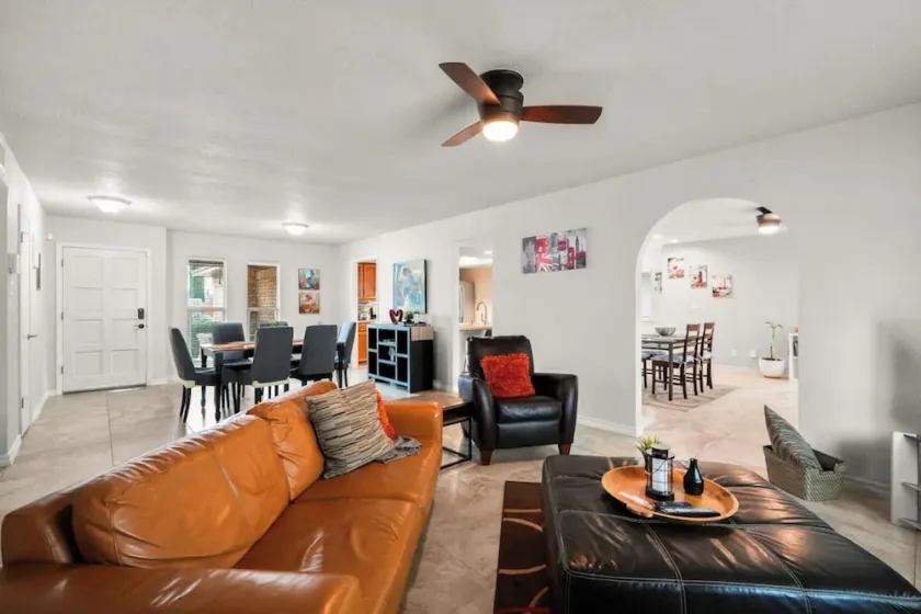 This spacious home has all you need with 2 primary suites, 2 guest bedrooms, and 3 bathrooms. There is no shortage of living space with a living room, 2 dining rooms, open floor plan w/fully-stocked kitchen, and onsite laundry. - Image 1
