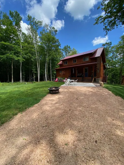 Family log home nestled in the woods just minutes from trails. - Image 1