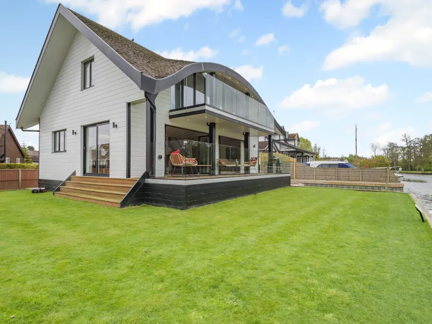 This stunning waterside home offers an amazing space for families and friends. - Image 1