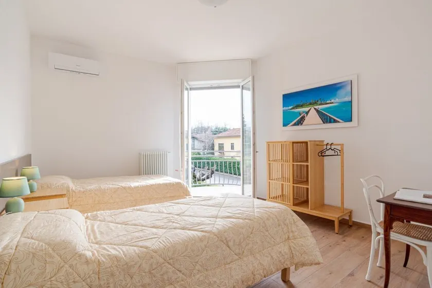 Travel with your family and friends and explore lakes and mountains near Como!This spacious apartment, with two bedrooms, two bathrooms, open space kitchen with island, large living room, small terrace, is located on the road that connects the two main c - Image 1