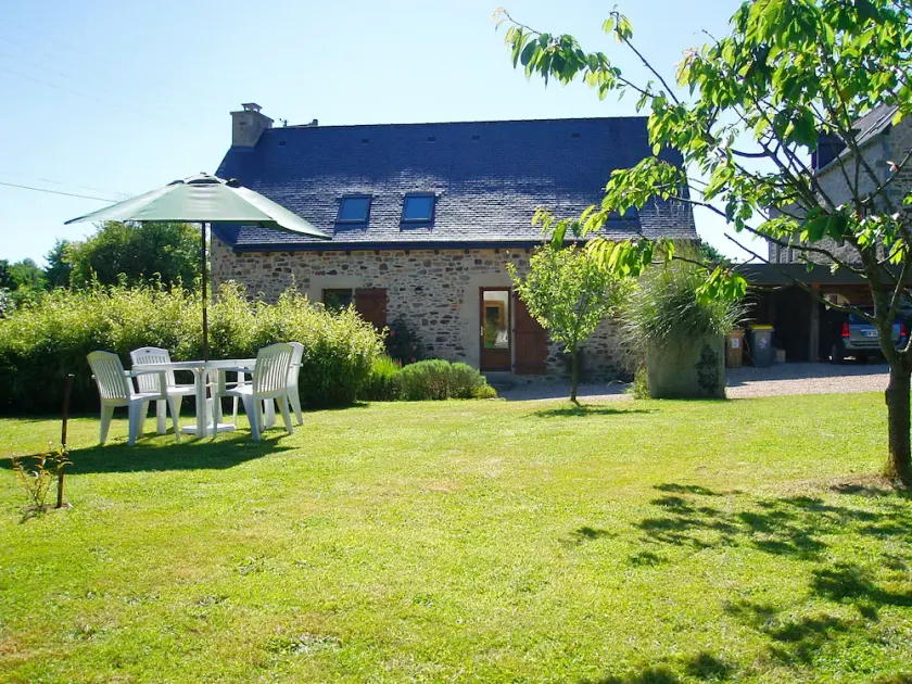 A cottage nestled in lush greenery. - Image 1