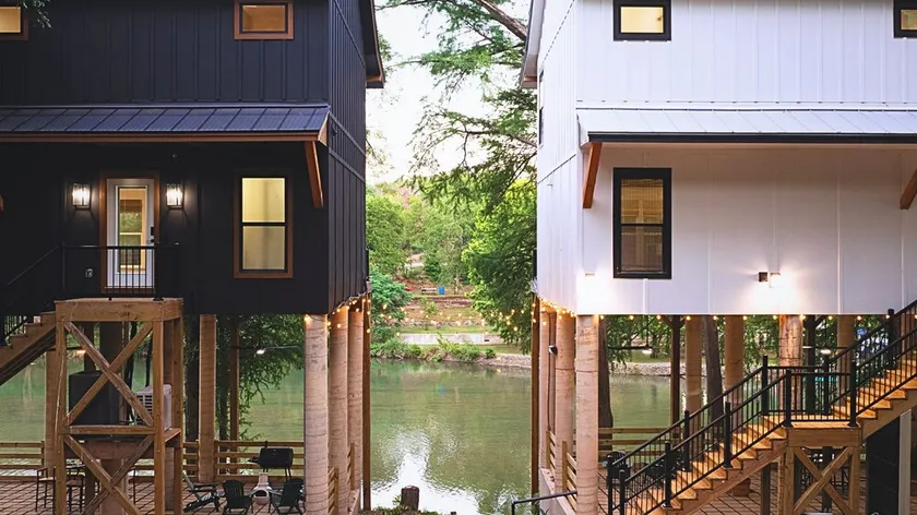 A unique Guadalupe River retreat featuring two stylish homes, private river access, a cozy fire pit, and a fun-filled game room—perfect for families, friends, and group getaways. - Image 1