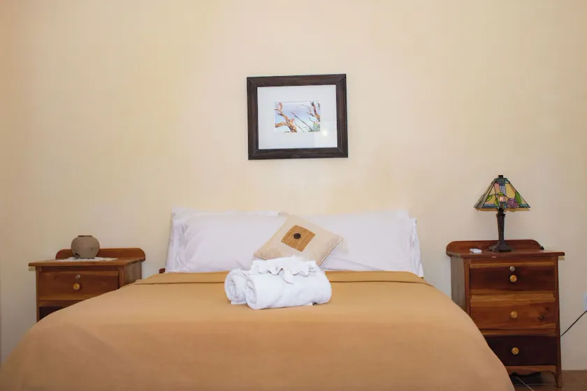 Queen-size bed, with a private bathroom, a walk-in shower and closet. - Image 1