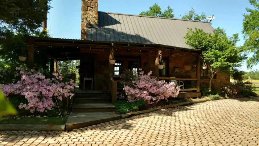 A rustic stone cottage on an estate close to the Texas State Railroad. - Image 1