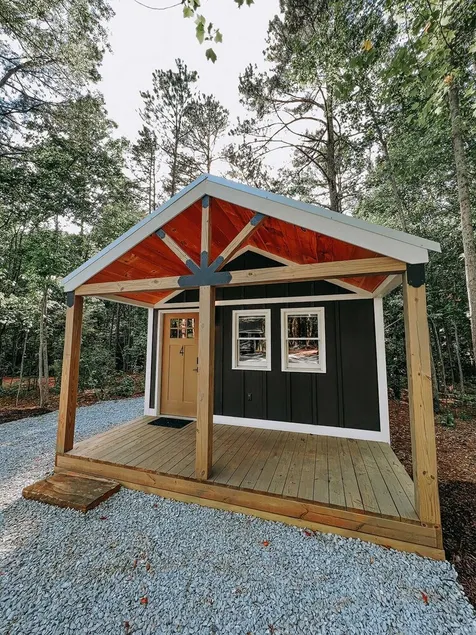 Cabin #4: Two queen-size beds with a kitchenette and a large gravel parking pad beside the cabin for easy boat or trailer storage. - Image 1