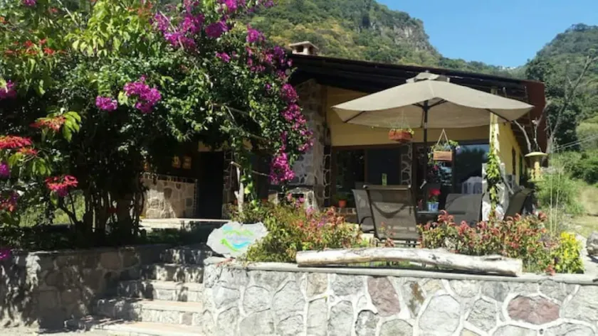 Cozy country cottage with wooden ceilings and stone walls within nature reserve. - Image 1