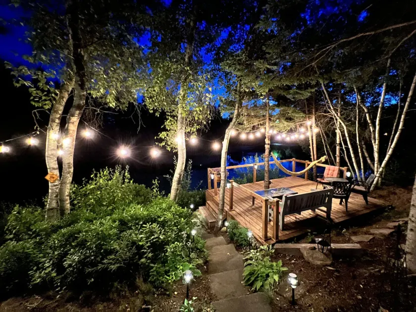 Luxurious secluded rustic wooden chalet on edge of tranquil pond next to beach. - Image 1