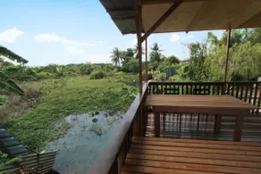 Tung's Tropika - with a wooden hut by a lake - Image 2