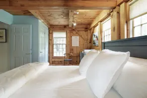 Get Cozy Under the Rustic Beams at a Woodland Hideaway - Image 4