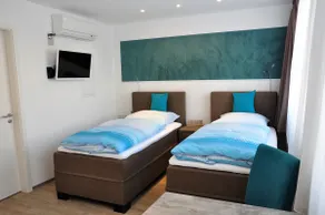 Modern one-room apartment with two single beds - Image 2