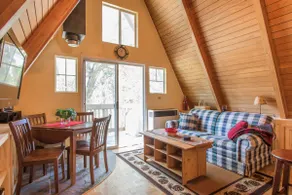 Small A-frame cabin on dirt road - Image 4