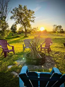 Rustic farmhouse with an outdoor fireplace. - Image 2