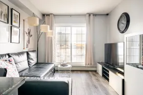 Sink into the Sleek Leather Sectional at an Open-Concept Pad - Image 4