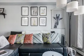 Sink into the Sleek Leather Sectional at an Open-Concept Pad - Image 2