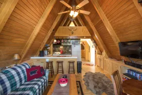 Small A-frame cabin on dirt road - Image 5