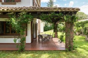 A villa with a large garden and a porch · Golf Costa Brava - Image 3