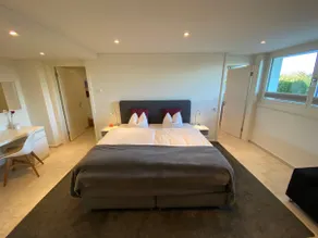 Luxurious hotel room surrounded by greenery - Image 2