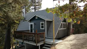 Small A-frame cabin on dirt road - Image 2