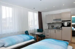 Modern one-room apartment with two single beds - Image 3