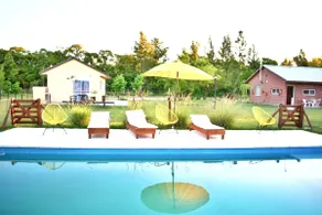 Cabin surrounded by greenery with a pool - Image 2