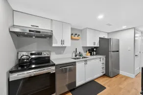 Bright and Modern 2BR Suite with Rustic Bar - Image 4