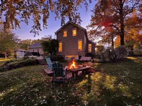 Fall colors on the river with kayaks and fire pit - Image 2
