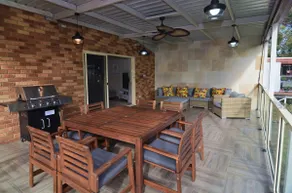 Coastal family retreat sun-drenched outdoor patio - Image 2