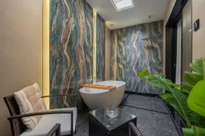 Luxury hotel suite with bathtub and sitting area - Image 5