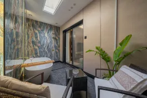 Luxury hotel suite with bathtub and sitting area - Image 3
