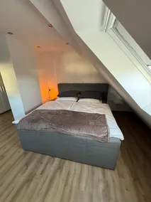 Stylish attic apartment with box spring bed - Image 2