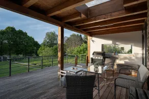 Modern cottage with large covered terrace by pond - Image 3
