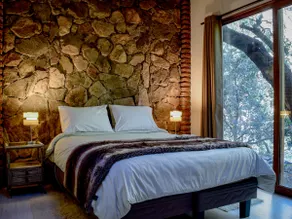 Stone house in the native forest · by the river - Image 2