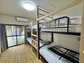 This is a unique space with a spacious living room with a large monitor and two bedrooms with bunk beds. - Image 4