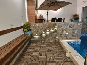 A house with a swimming pool, waterfall, grill, and artesian oven - Image 4