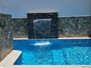 A house with a swimming pool, waterfall, grill, and artesian oven - Image 3
