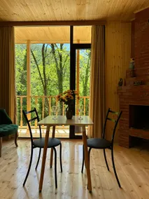 Parna’s riverside cabin surrounded by green forest - Image 4