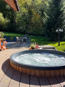 A year-round, covered, heated swimming pool and a hot tub. - Image 3